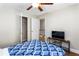Inviting bedroom with blue patterned bed, features closet and TV on a sleek stand at 6604 Destiny Se Dr, Mableton, GA 30126