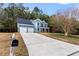 Charming two-story blue house with a two-car garage and a spacious front yard at 6604 Destiny Se Dr, Mableton, GA 30126