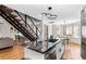 Open kitchen featuring stainless steel appliances, a granite island, and a modern staircase leading to the second floor at 6604 Destiny Se Dr, Mableton, GA 30126