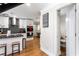 Updated kitchen featuring stainless steel appliances, granite countertops, an island with seating, and a nearby powder room at 6604 Destiny Se Dr, Mableton, GA 30126