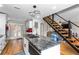 Spacious kitchen with a large island, stainless steel appliances, and a modern staircase leading to the second floor at 6604 Destiny Se Dr, Mableton, GA 30126