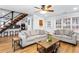 Open floor plan with hardwood floors, metal staircase and neutral colored furniture at 6604 Destiny Se Dr, Mableton, GA 30126