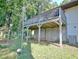 A raised wooden deck with railing, supported by posts, overlooks the backyard with some playground equipment at 1453 Midview Dr, Decatur, GA 30032