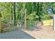 This backyard features a patio area with stairs leading down to a fenced-in yard surrounded by lush greenery and trees at 1453 Midview Dr, Decatur, GA 30032
