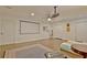 Finished basement features a projector, movie screen and ceiling fan with hardwood flooring and plenty of space at 1453 Midview Dr, Decatur, GA 30032