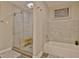 Bright bathroom with stylish tile, glass enclosed shower, soaking tub and a wood bench at 1453 Midview Dr, Decatur, GA 30032