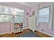 Charming bedroom featuring hardwood floors, a white dresser, and soft, natural light at 1453 Midview Dr, Decatur, GA 30032