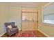 Bedroom featuring a comfy blue chair, decorative rug and a window for natural light at 1453 Midview Dr, Decatur, GA 30032