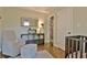Bedroom boasts a comfortable gray glider, books, wooden floors and ample natural light at 1453 Midview Dr, Decatur, GA 30032
