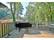 Outdoor deck with a grill surrounded by lush greenery, perfect for outdoor cooking at 1453 Midview Dr, Decatur, GA 30032