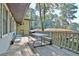 A large wooden deck with picnic table seating with the house next door in the background at 1453 Midview Dr, Decatur, GA 30032