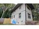 View of the side of the two-story home featuring grey siding and a wooden fence at 1453 Midview Dr, Decatur, GA 30032