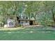 Charming two-story home with a covered carport and lush, mature trees in a large front yard at 1453 Midview Dr, Decatur, GA 30032