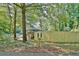 Exterior view of a house with a wooden fence and Little Free Library in a wooded area at 1453 Midview Dr, Decatur, GA 30032