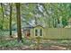Exterior view of a house with a wooden fence and Little Free Library filled with books in a wooded area at 1453 Midview Dr, Decatur, GA 30032