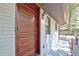 Close-up of the wood front door, showcasing its modern design, and a modern security system at 1453 Midview Dr, Decatur, GA 30032