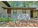 Charming front porch with brick and siding exterior, featuring a wood railing and a beautiful wooden front door at 1453 Midview Dr, Decatur, GA 30032