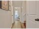 Hallway with light grey walls, white trim, hardwood floors and a view of a room at 1453 Midview Dr, Decatur, GA 30032