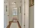 Hallway with hardwood flooring, neutral paint, and several entryways into separate rooms at 1453 Midview Dr, Decatur, GA 30032