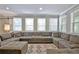 Bright living room with large sectional, a patterned rug, and multiple windows at 1453 Midview Dr, Decatur, GA 30032