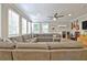 Inviting living room with a large sectional sofa, ample natural light, and a ceiling fan at 1453 Midview Dr, Decatur, GA 30032