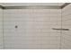 A shower stall is lined with sleek white subway tile and a decorative accent border at 1453 Midview Dr, Decatur, GA 30032