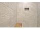Walk-in shower with gray tile surround and a built in shelf and wooden bench at 1453 Midview Dr, Decatur, GA 30032