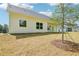 Backyard with view of the covered patio and rear of the home at 1471 Stephens View Dr, Loganville, GA 30052