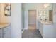 Bathroom with granite countertops, a glass enclosed shower, and an entrance to a walk-in closet at 1471 Stephens View Dr, Loganville, GA 30052