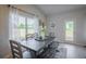 Dining space bathed in natural light, features an outdoor view, and a rustic dining set at 1471 Stephens View Dr, Loganville, GA 30052