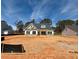 New home with neutral siding, dark shutters, and a covered front porch at 1471 Stephens View Dr, Loganville, GA 30052