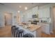 Spacious kitchen island with bar stool seating, pendant lighting, and stainless appliances at 1471 Stephens View Dr, Loganville, GA 30052