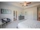 Bright main bedroom featuring a ceiling fan, tray ceiling, and a sitting area for relaxation at 1471 Stephens View Dr, Loganville, GA 30052