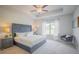 Serene primary bedroom showcasing a tray ceiling, plush carpeting, and ample natural light at 1471 Stephens View Dr, Loganville, GA 30052
