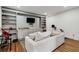 Spacious basement living area with a comfortable sofa, built-in shelving, and recreational equipment at 1828 Almeta Ne Ave, Atlanta, GA 30307