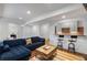 Finished basement featuring a seating area, bar, neutral colors and modern lighting at 1828 Almeta Ne Ave, Atlanta, GA 30307