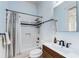 Bright bathroom features a combination shower and tub, modern sink, and classic fixtures for a stylish and functional space at 1828 Almeta Ne Ave, Atlanta, GA 30307