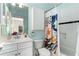 Bathroom with modern shower curtain, white vanity and blue walls at 1828 Almeta Ne Ave, Atlanta, GA 30307