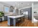 Modern kitchen featuring a large island, stainless steel appliances, and stylish pendant lighting at 1828 Almeta Ne Ave, Atlanta, GA 30307