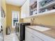 Functional laundry room featuring modern washer and dryer, sink, and ample storage space in a well-lit area at 1828 Almeta Ne Ave, Atlanta, GA 30307