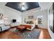Spacious main bedroom with tray ceiling, hardwood floors, and an inviting seating area with plenty of natural light at 1828 Almeta Ne Ave, Atlanta, GA 30307