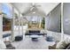 Relaxing screened porch with comfortable seating, ceiling fan, and natural light filtering through the surrounding trees at 1828 Almeta Ne Ave, Atlanta, GA 30307