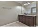 Clean bathroom with dual sink vanity, granite countertop, dark cabinets, and a large mirror at 212 Long Dr, Mcdonough, GA 30253