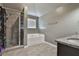Well-maintained bathroom featuring a separate shower, soaking tub, and a large window for natural light at 212 Long Dr, Mcdonough, GA 30253