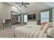 Spacious bedroom with vaulted ceiling, a large bed and a connected playroom area provides extra flexibility and fun at 212 Long Dr, Mcdonough, GA 30253