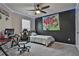 Gaming themed room with light up decor, dark accent wall, a ceiling fan, and a comfortable gaming setup at 212 Long Dr, Mcdonough, GA 30253