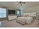 Comfortable bedroom with a ceiling fan, large dresser, a stylish bed, and ample natural light from two windows at 212 Long Dr, Mcdonough, GA 30253