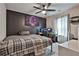 Bedroom with a dark accent wall, and a gaming setup, creating an engaging space for relaxation and recreation at 212 Long Dr, Mcdonough, GA 30253