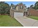 Charming two-story home with brick and tan siding, front lawn, and two-car garage at 212 Long Dr, Mcdonough, GA 30253