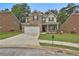 Charming two-story home with brick and tan siding, front lawn, and two-car garage at 212 Long Dr, Mcdonough, GA 30253